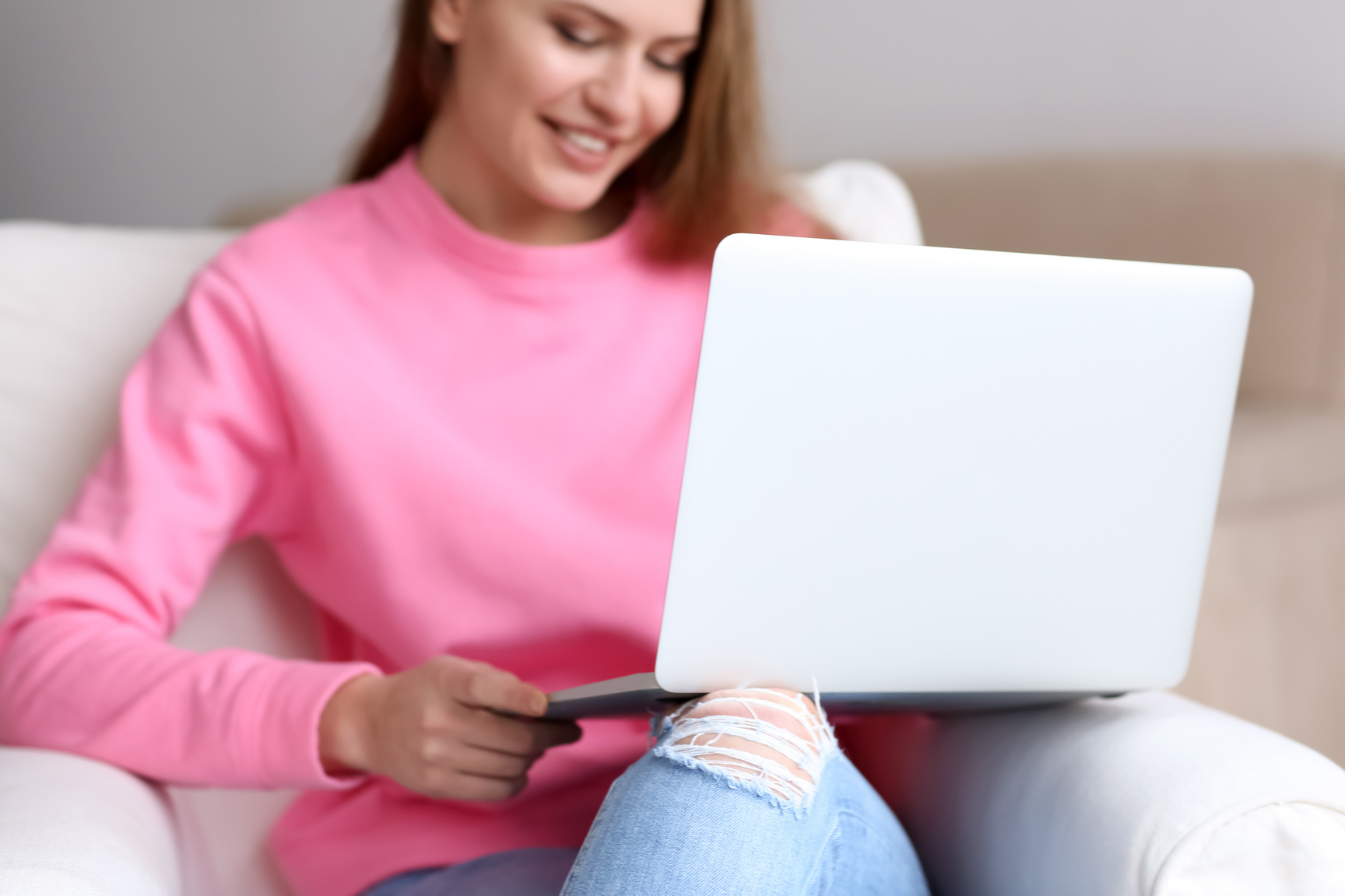 Young Woman Using Laptop Indoors